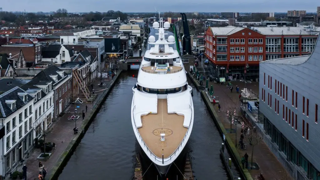 The Feadship team moves Tilman Fertitta's super yatch, Boardwalk, through the narrow canals of The Netherlands on its way to sea trials. (Photo courtesy of Feadship)