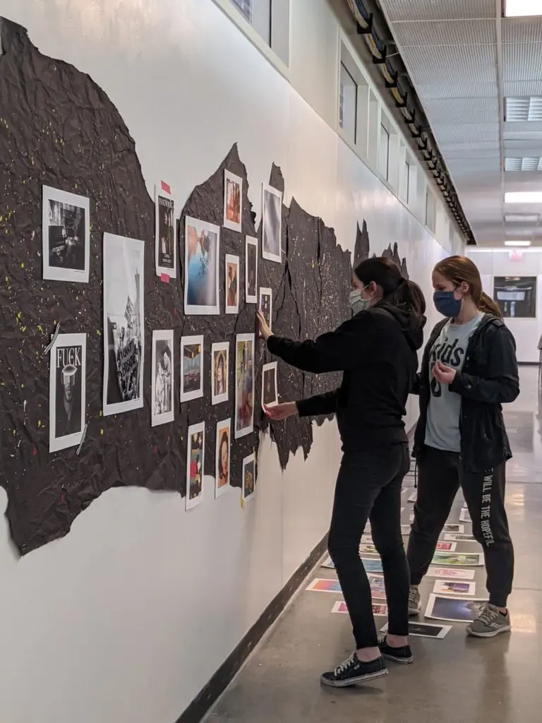 Co-curators, Taryn Gonzales and Cassidy Matlock, prepare for opening day of "!@#$ 2020." 