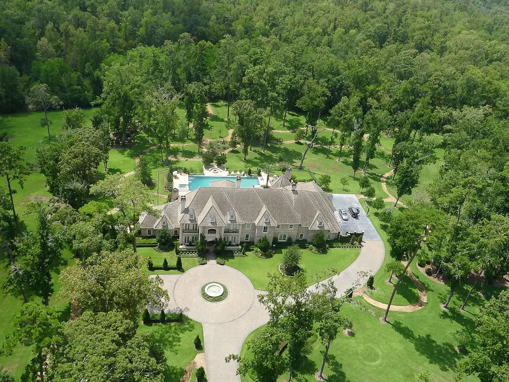The massive mansion at 126 S Tranquil Path in The Woodlands sits on nine wooded acres.