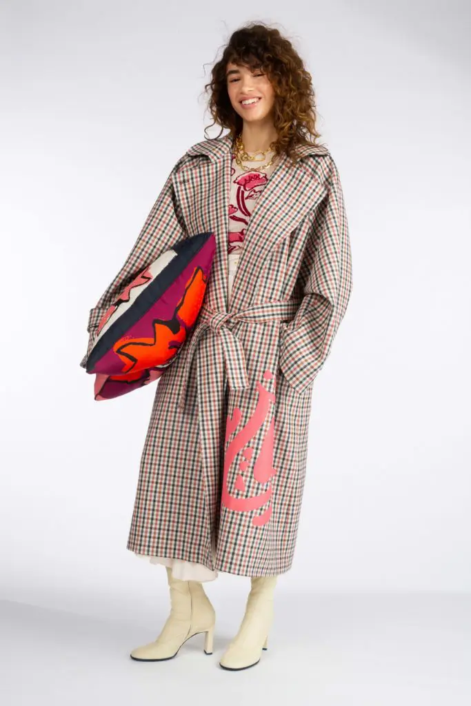 Tanya Taylor check overcoat with pink detail, print dress, gold necklace. (Photo courtesy of Tanya Taylor)