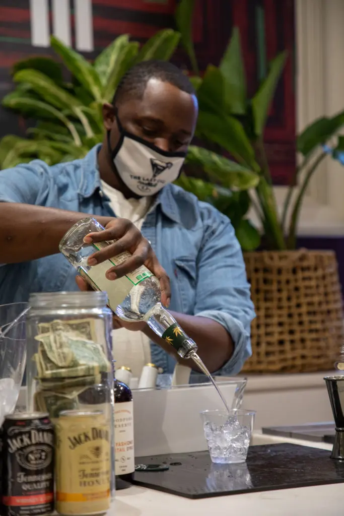 Bartender, Clif Taylor, was a popular man all night at the opening of "Collect It For the Culture III." (Photo by Nicole Electra)