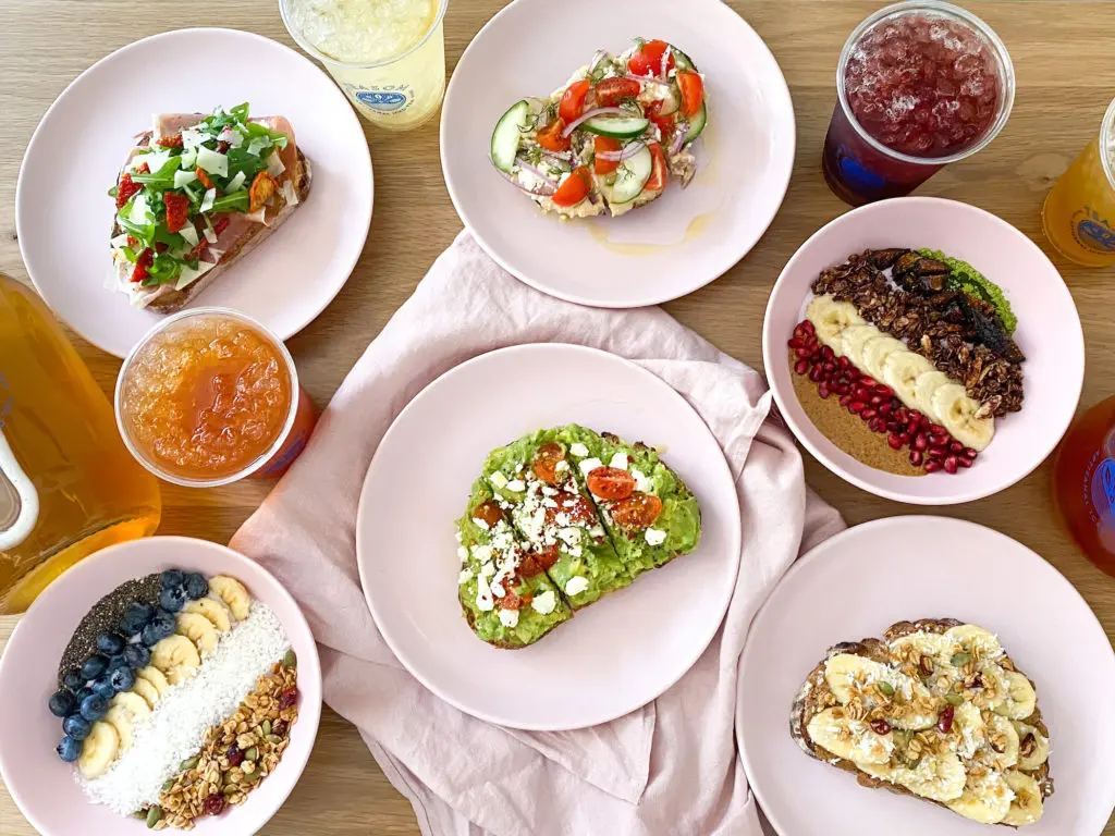 A healthy menu includes avocado toast, coconut milk yogurt bowls, kale salad, and breakfast sandwiches made with predominately locally sourced ingredients. 