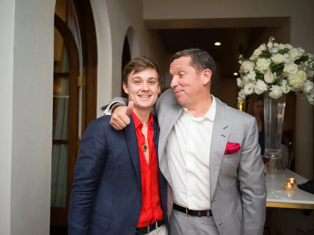 Robert Moody III, brother of the bride, shares a moment with Tony Buzbee at the engagement party.