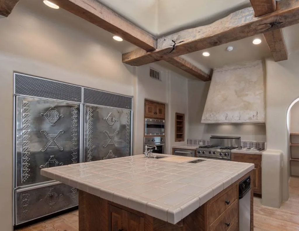 In George Strait's San Antonio home, the double SubZero freezers are covered in an intricate and hand-drawn copper design treatment that was finished in silver (Photo by LRES)