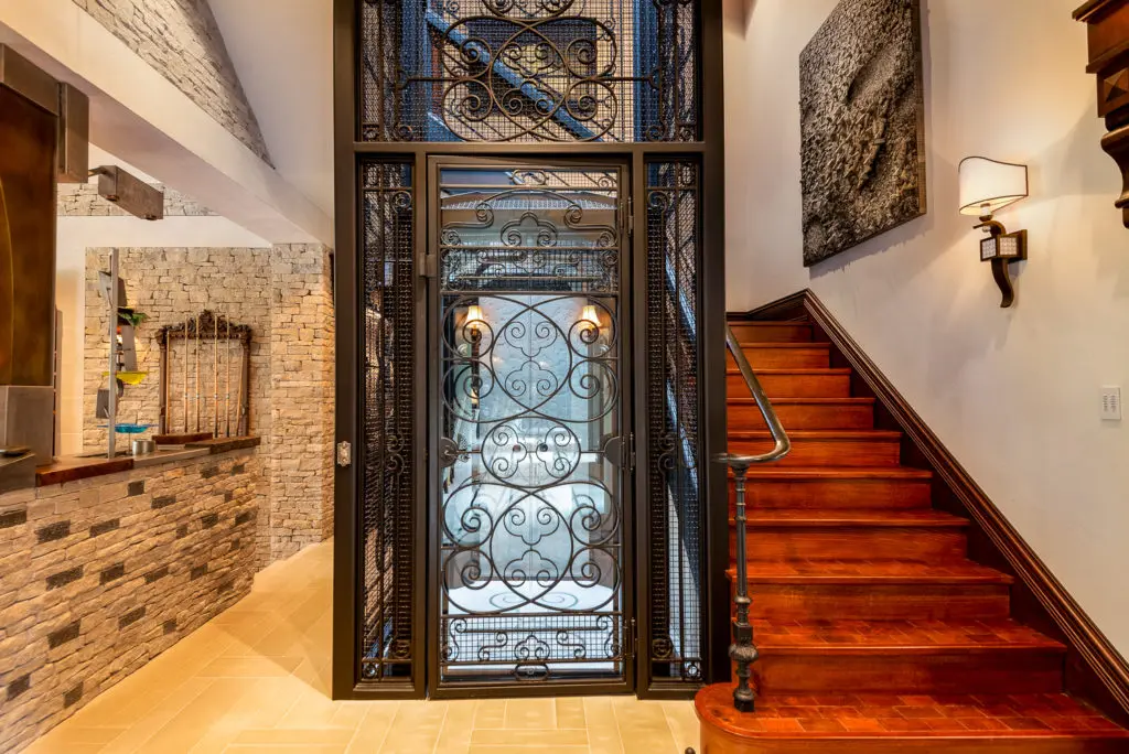 Old world details include a quaint, caged elevator. 