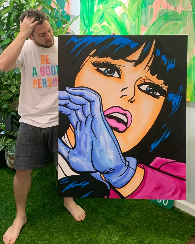 Captain Casual has created a Love and Kindness mural for Uptown Dallas, which will be unveiled on February 8 in Griggs Park. The artist holds one of his pieces. (Courtesy Shauna Glenn Design)