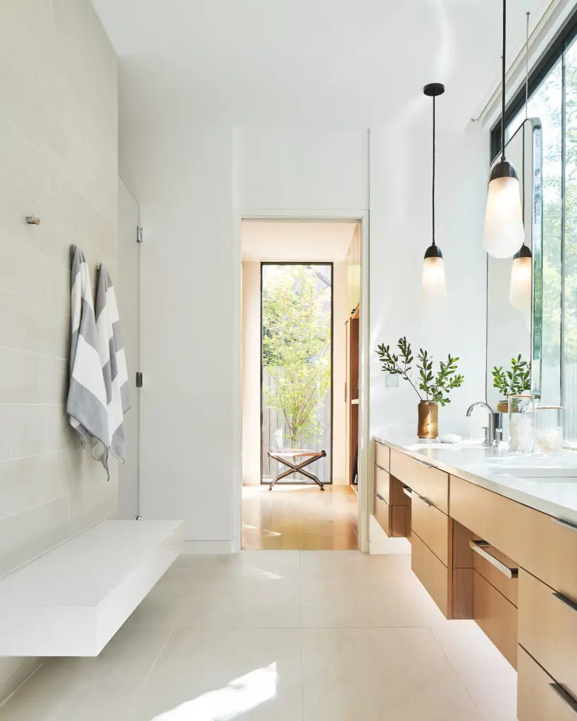 In the master bath, Apparatus pendants, Noir stool, Caesarstone countertops. (Photo by Stephen Karlisch)