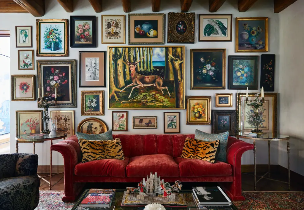 In the sitting room, paintings and embroideries in original frames, discovered in Paris. Antique side tables from Palm Beach. Sixties-era sofa in Pierre Frey velvet from Scout. (Photo by Pär Bengtsson)