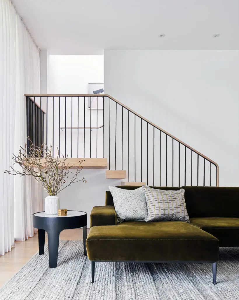 In the family room are a Modloft sectional reupholstered in green Duralee velvet, custom pillows from Muriel Brandolini and Seema Krish, and Noir side table. (Photo by Stephen Karlisch)