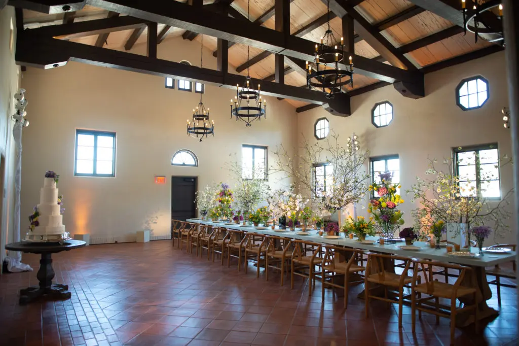 The former men's locker room at Lott Hall is set for a dinner for 24 with florals by Bergner & Johnson. The venue can handle 150 for a seated affair. (Photo by Sarah Austin of Chris Bailey Photography)