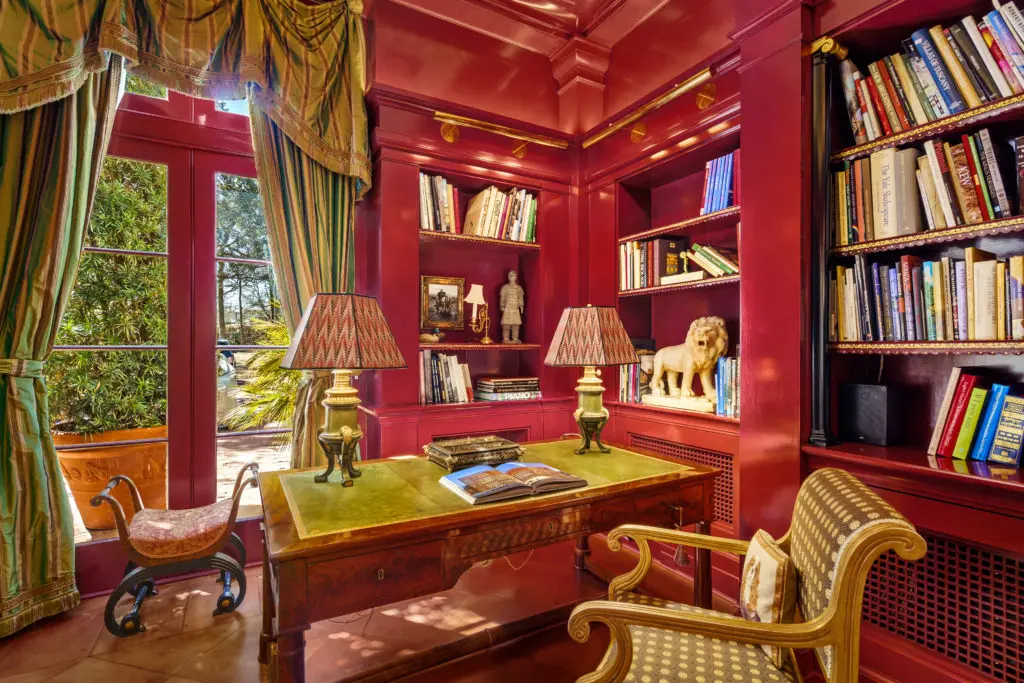 The library in the Gerald Hines River Oaks home is painted in a deep red and features leather tile flooring. (Photo by Sonya Bertolino)