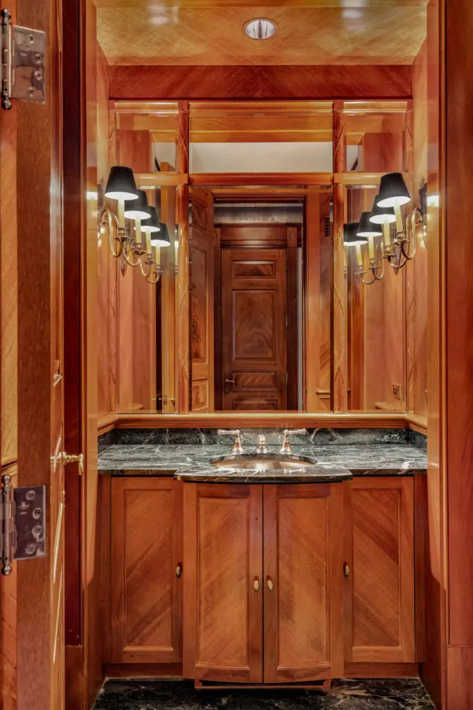 Beautiful woodworking brings special elegance to the powder room in the Gerald Hines River Oaks residence. (Photo by Sonya Bertolino)