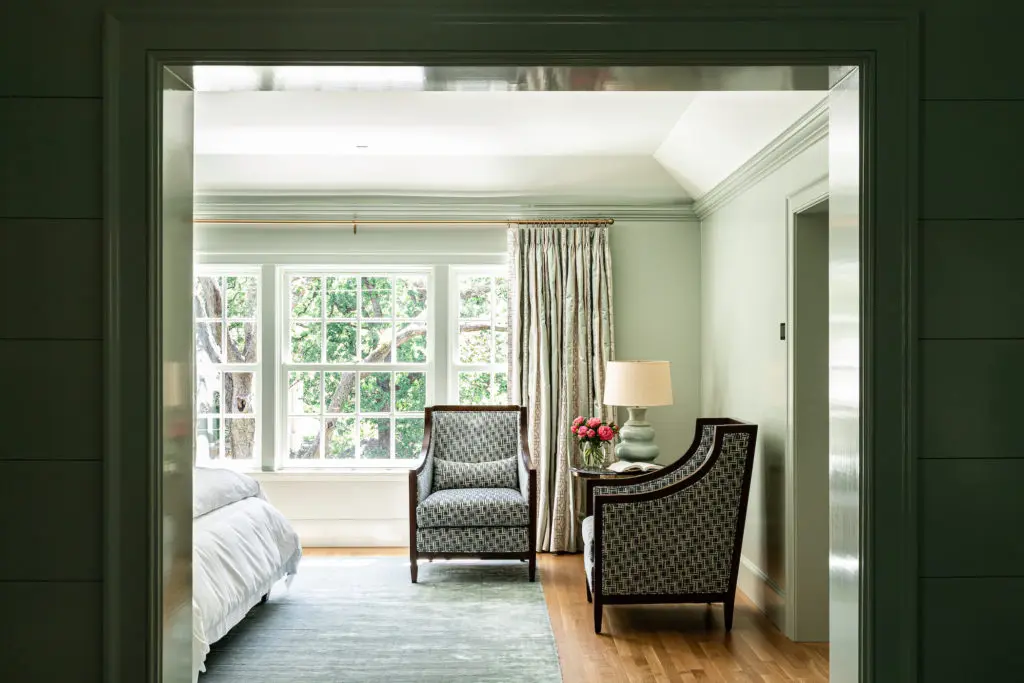 In the main bedroom is a pair of Bolier chairs in Lee Jofa fabric. Window treatments by Cowtan & Tout. (Photo by Manny Rodriguez)