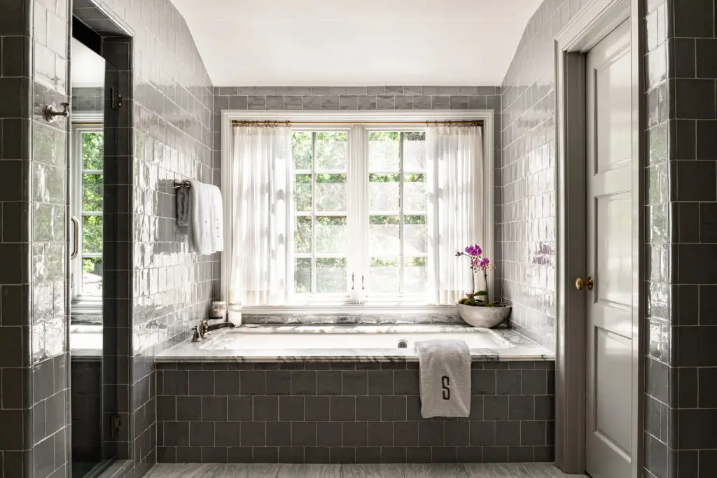 The master bathroom’s tile is handmade. The Kohler tub has been customized with tile and marble. (Photo by Manny Rodriguez)