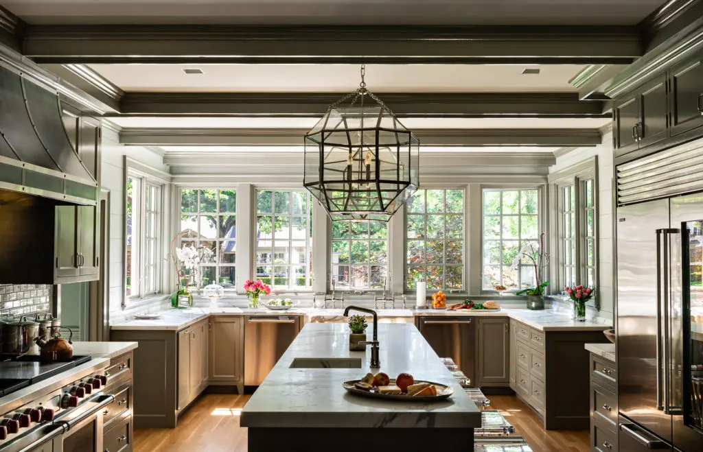 The kitchen is painted in Farrow & Ball and Benjamin Moore flax, pigeon, and gray paints. Light fixture Suzanne Kasler for Visual Comfort. Sub-Zero and Wolf appliances. (Photo by Manny Rodriguez)
