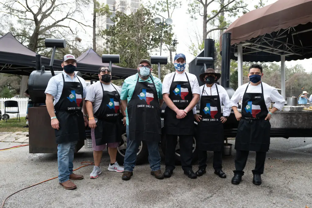 The Smokin' Since '79 team join the masked adventure at The Houstonian's inaugural BBQ on the Bayou Cook-off.