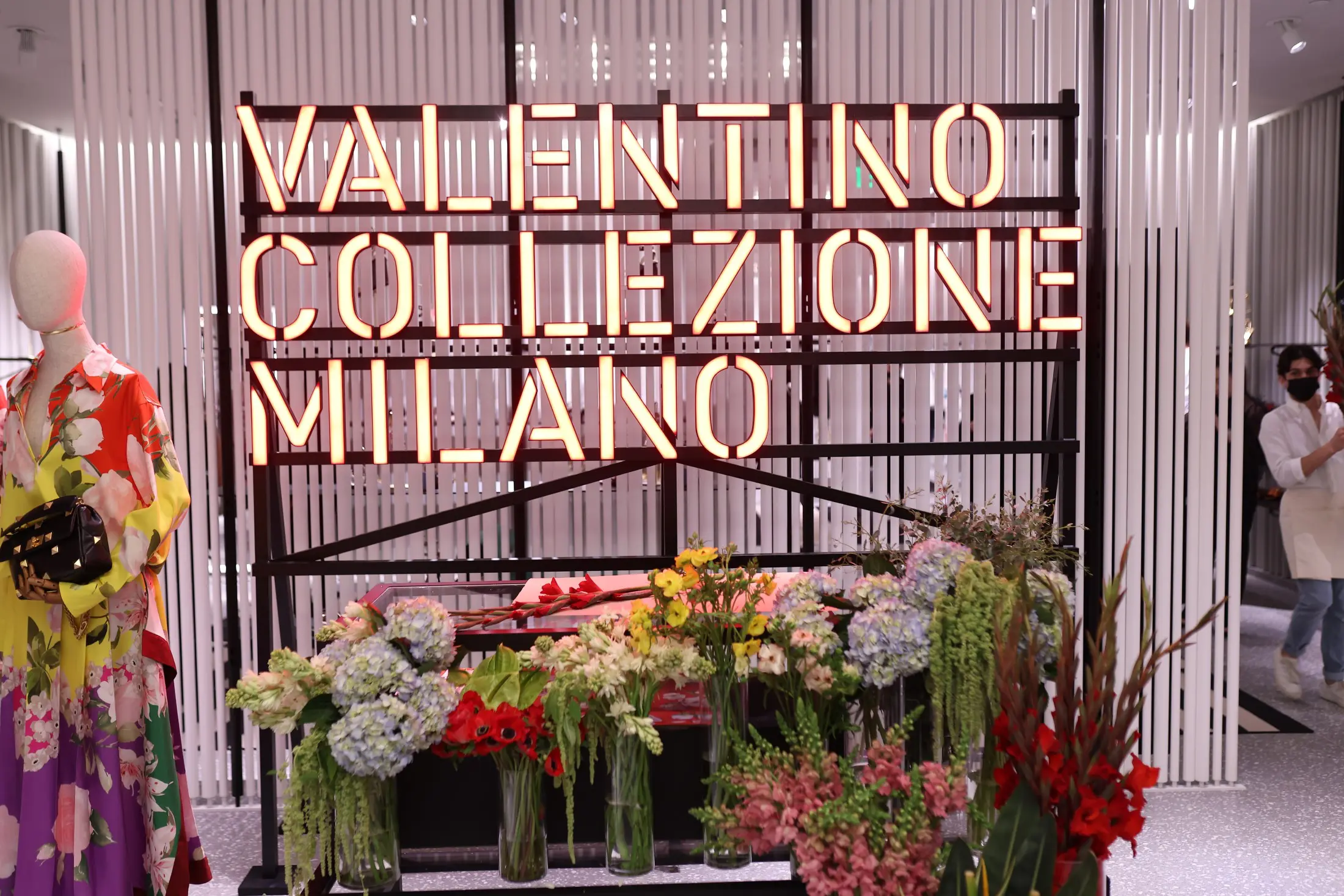 The Valentino traveling neon logo with floral bar welcomed guests to the new boutique in Houton's Galleria. (Photo by Quy Tran)