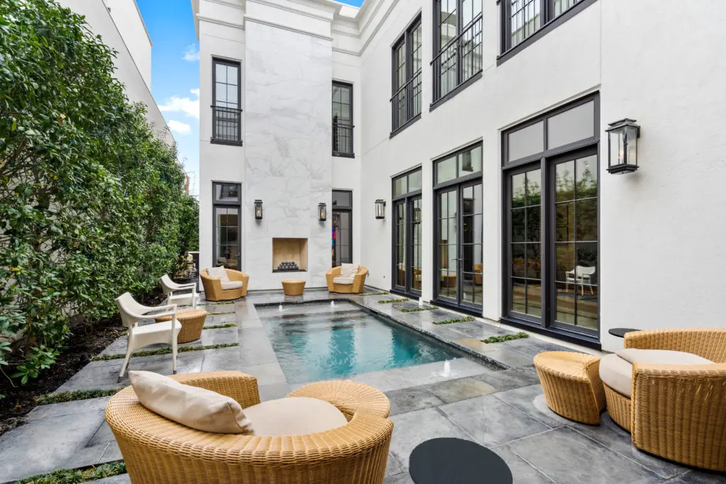 From the outside, 2521 Westgate displays a contemporary twist on neoclassical architecture. Upon entry through an arched gateway, a direct line of sight allows striking views through the front door, past the courtyard and entry foyer into a secluded pool courtyard with a spectacular two-story outdoor fireplace as the perfect centerpiece.