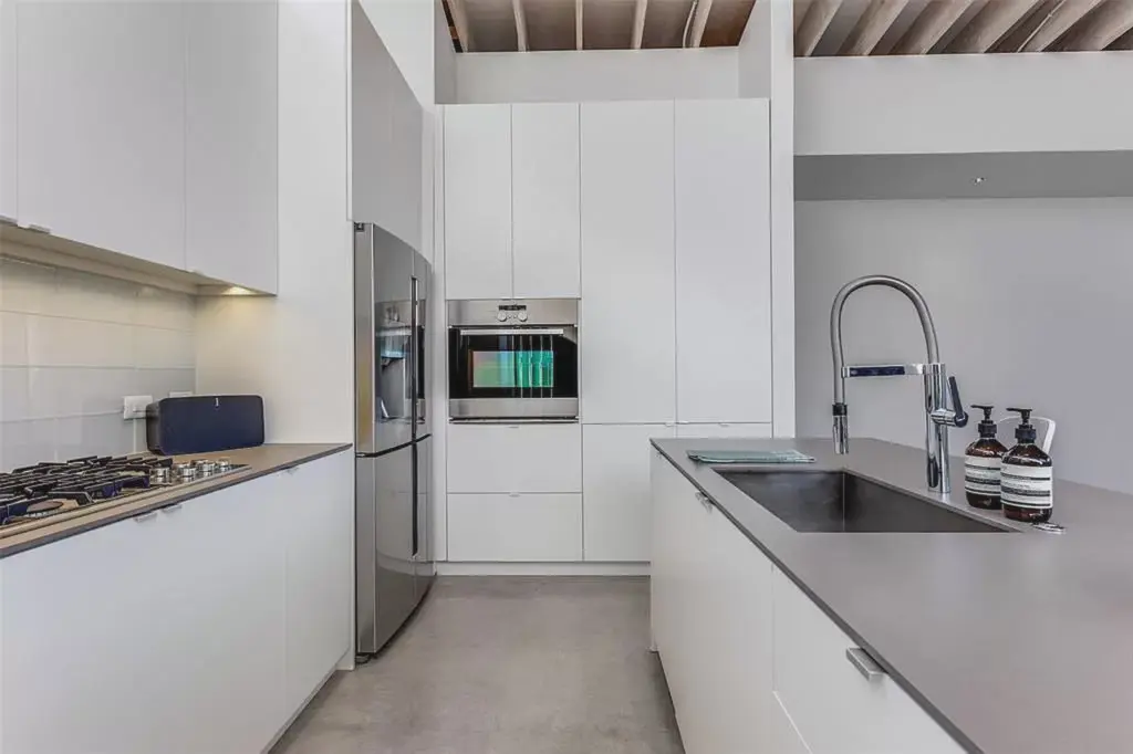 A clean-lined kitchen leads into the dining and leaving rooms. 