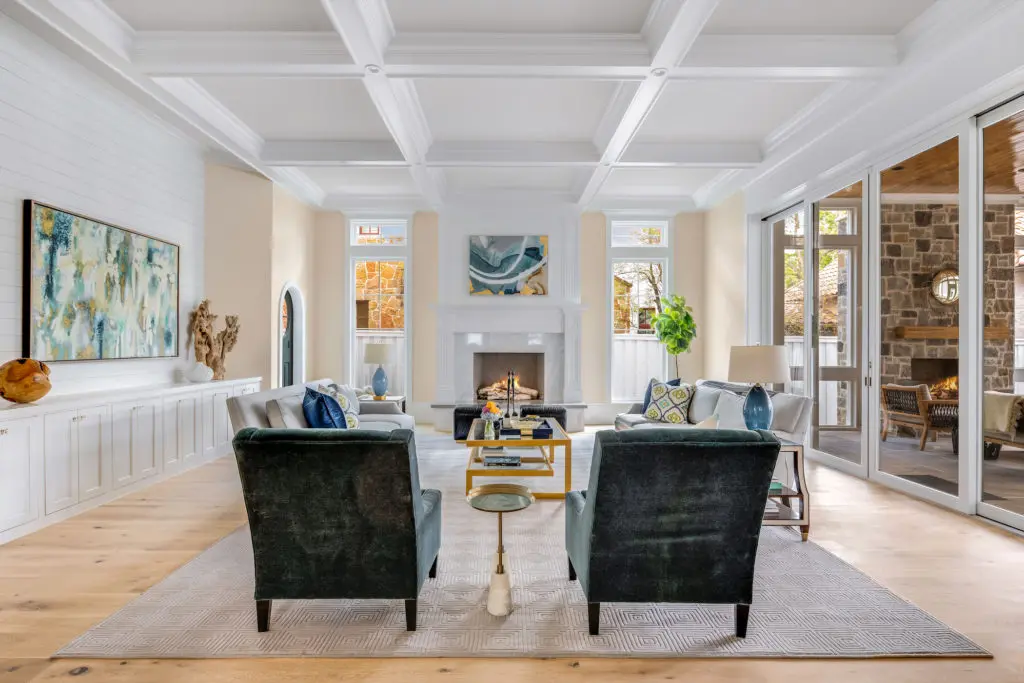 A spacious living area leads to the glass-enclosed patio. (Photo courtesy of Compass Real Estate) 