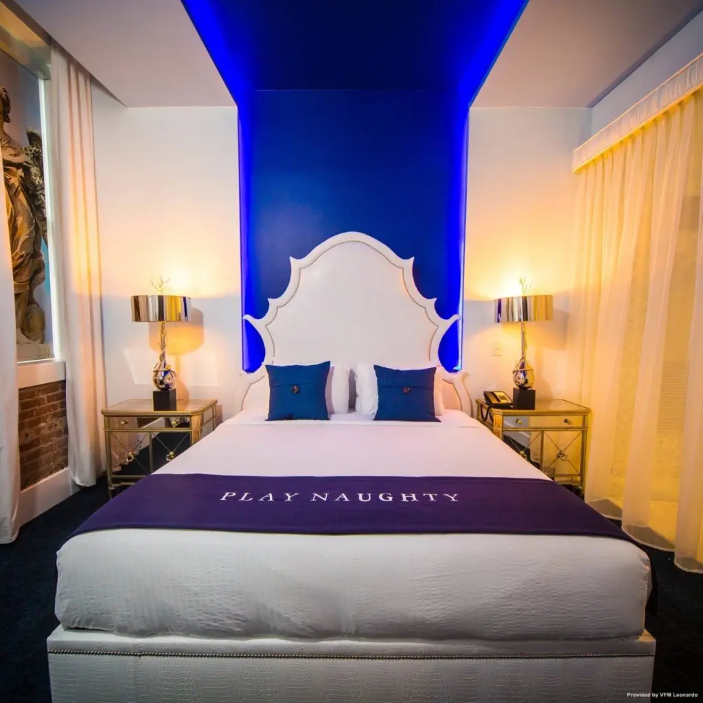 A typical guest room in The Saint Hotel New Orleans where the throws send a message. 