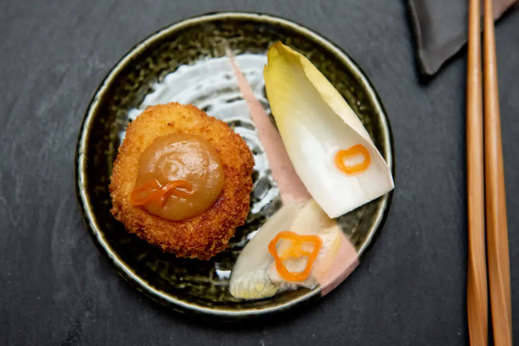 Enjoy a course of Crab Agemono, Orange Miso Brown Butter Emulsion, with Pickled Endive and Habanero at ReikiNa. (Photo by Kat Ambrose)