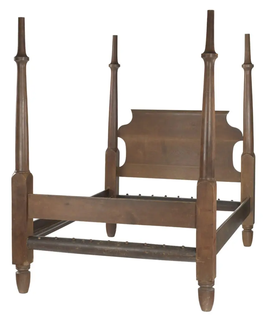 A wooden four poster bed frame with head board and foot board. The side rails screw into the frame providing greater strength and limited hiding places for vermin. This type of frame is known as the "Boyd Bedstead." Henry Boyd's Bedstead," from the  Collection of the Smithsonian National Museum of African American History and Culture.