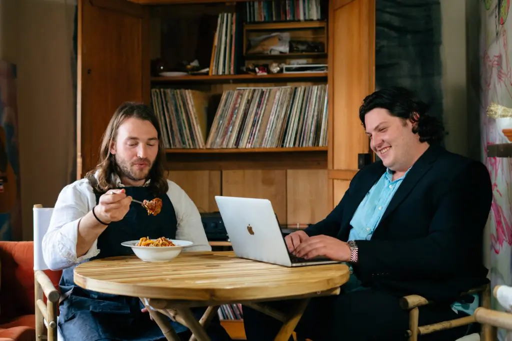 Thomas Stacy and Andrew Herron enjoy a bowl of pasta and Stacy's curated vinyl collection (photo by Yan).
