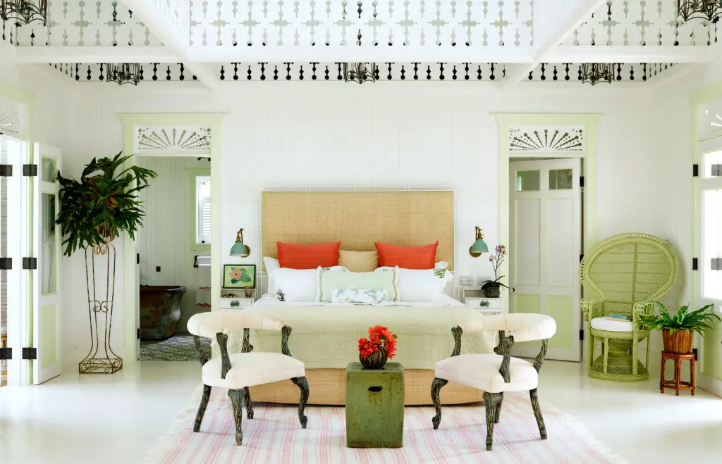 Changing the mood of a room with red torch ginger flowers echoed with big poppy-red Euro shams on bed.