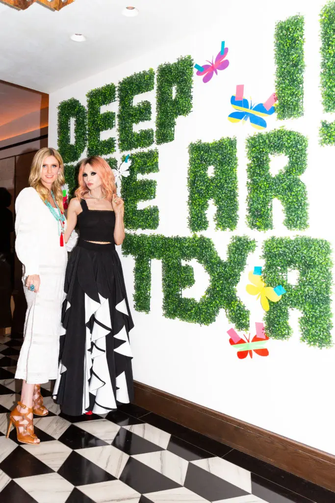 Nicky Hilton and Stacey Bendet pose with Donald Robertson's "Deep in the Art of Texas." (Getty) 