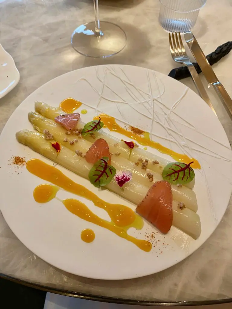 Le Jardinier French White Asparagus with Orange Reduction, Puffed Buckwheat, Green Strawberries with edible floral accents. (Photo by Shelby Hodge)