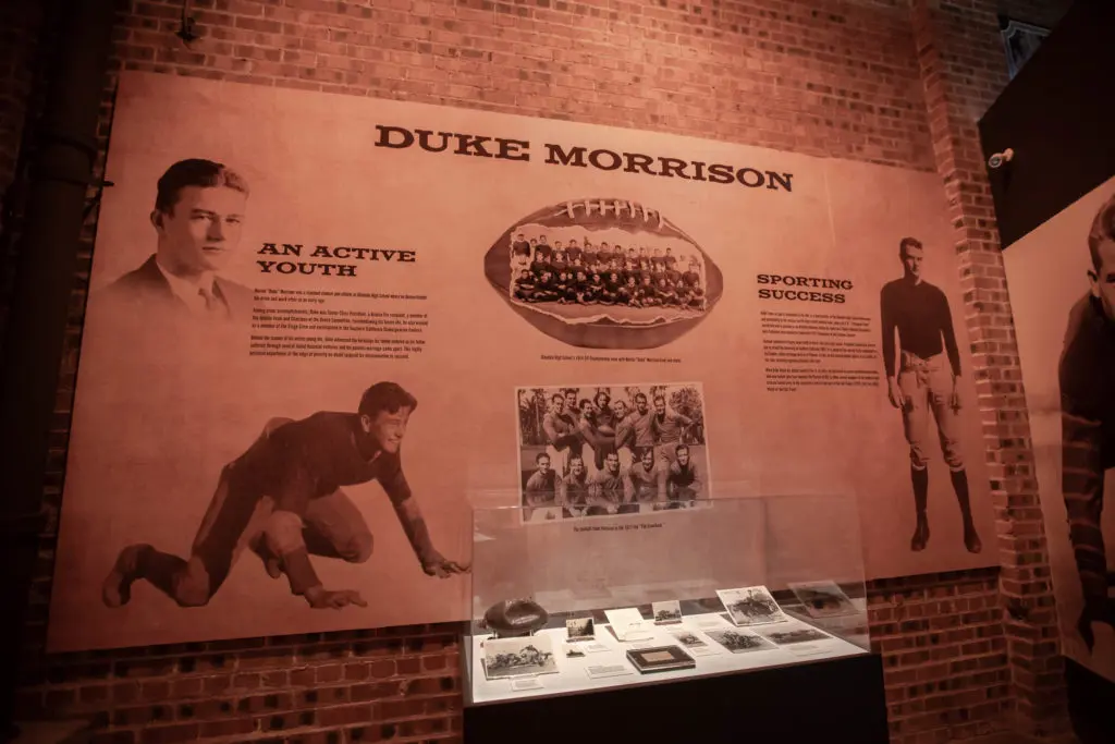 The exhibit begins with a young man named Duke Morrison.