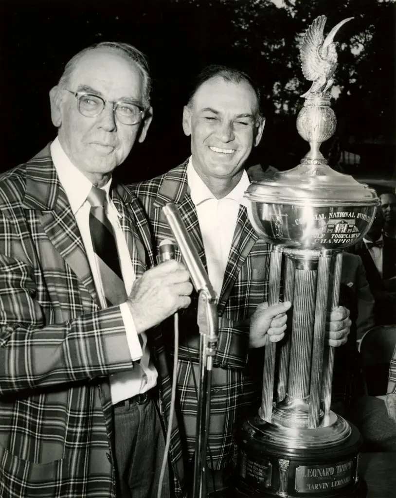 Marvin Leonard and Ben Hogan wrapped in plaid jackets holding the Leonard Trophy after one of Hogan's Colonial wins.