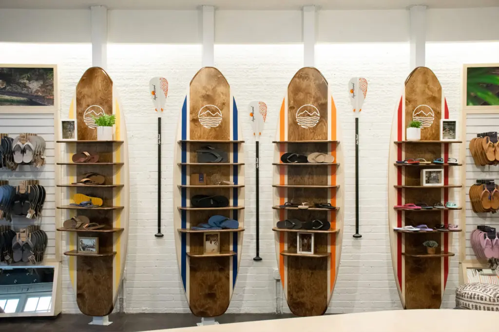 In addition to their luxe flip flops, Hari Mari's popular water shoes are appropriately displayed on surfboards. 