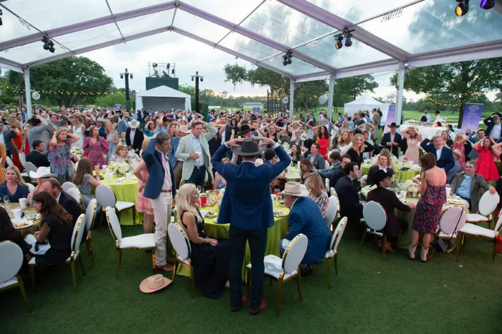 The Children's Fund partygoers participated in a game of heads or tails in hopes of winning a spa and golf weekend at the Omni Barton Creek. (Photo by Wilson Parish)
