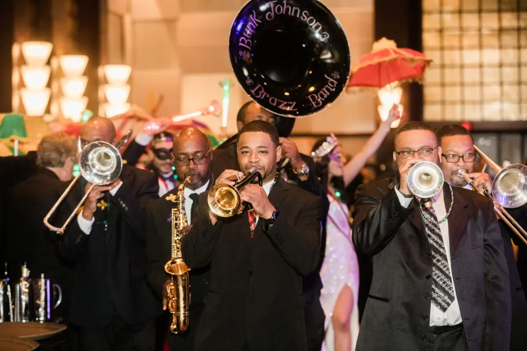 The Buzz Johnson Brazz Band lead the parade through the University of St. Thomas Mardi Gras Ball, 2021.