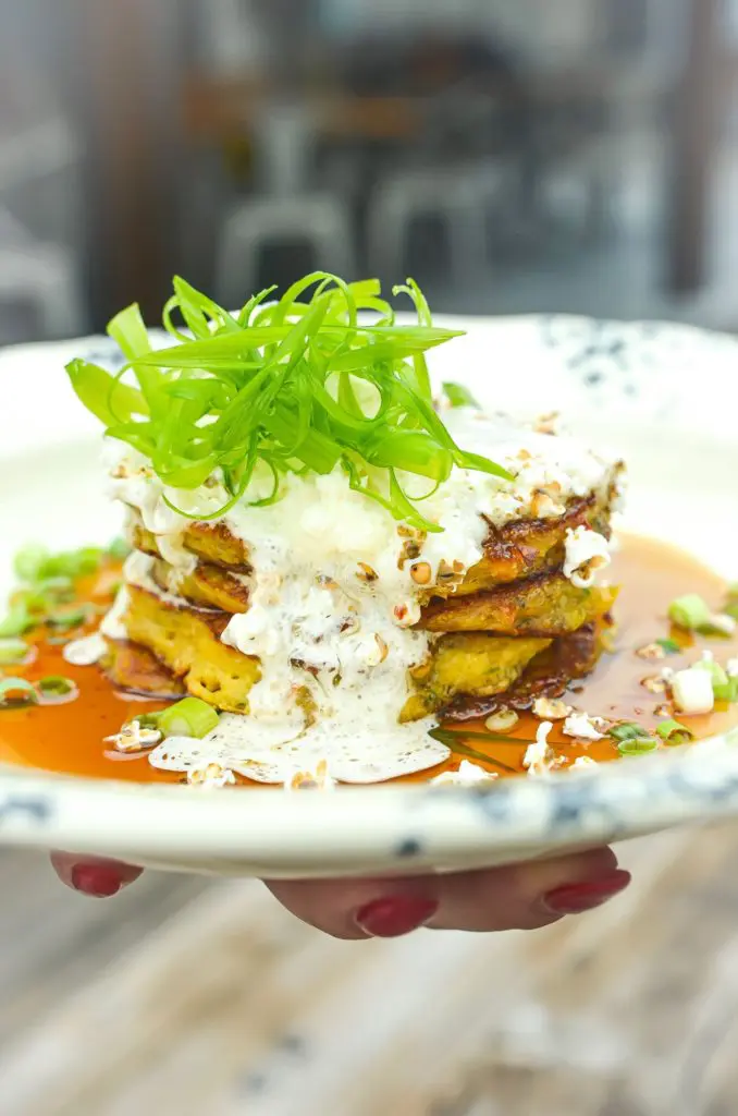 Whistle Britches - Southern style sweet corn hoecakes, with jalapeño cane syrup, honey butter, popped gorghum, ginger, and shaved scallion.