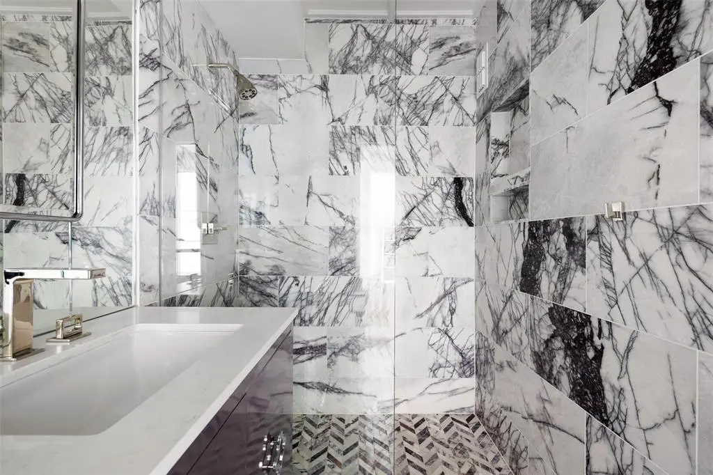 The shower in the 16th floor condo at 1400 Hermann is clad in Milas lilac honed marble.