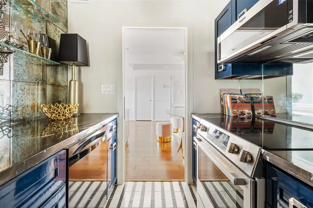 Calacatta marble on the kitchen floor is one of many design upgrades in this 16th floor condo at 1400 Hermann.