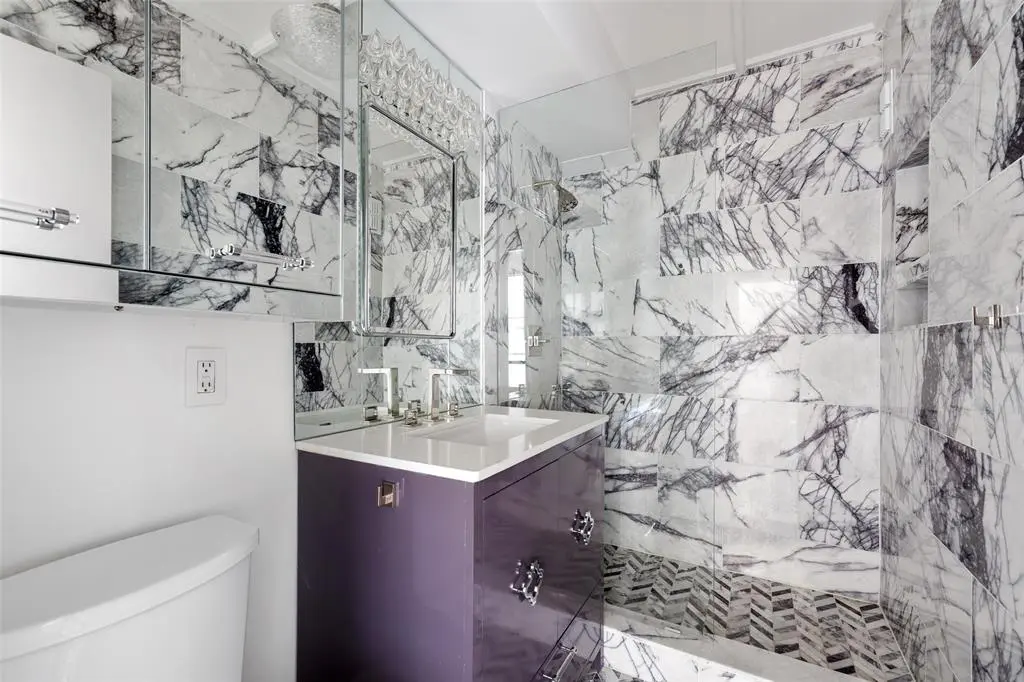 The custom vanity is covered in high-gloss lavender lacquer in the 16th floor condo at 1400 Hermann.