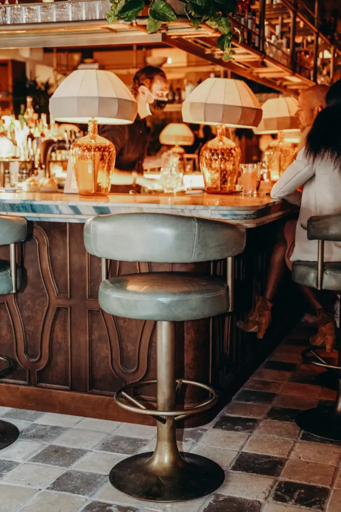 Soho House Austin's main bar includes a hand-carved wooden front with large linen lanterns that set the mood above.  (Photo by Cristina Fisher)