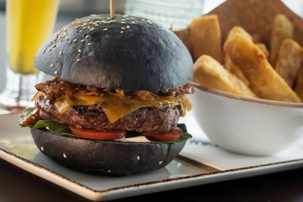 Good Graces features a burger made with shallot jam, bone barrow aioli, and a squid-ink bun. (Courtesy)