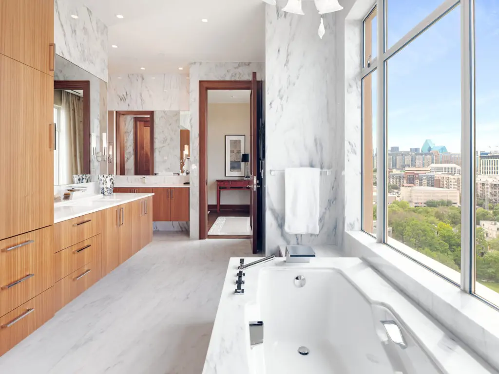 Natural light highlights the white marble of the master bathroom. (Photo by Sean Gallagher Photo)