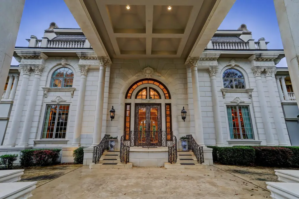 Dual limestone balustrade stairways define the entry to the four-acre mansion at 8 Deer Ridge Estates Boulevard. (Photo by TK Images)