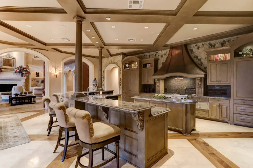 Marble inlaid with wood provides a rich flooring pattern in the kitchen and breakfast room. (Photo by TK Images)