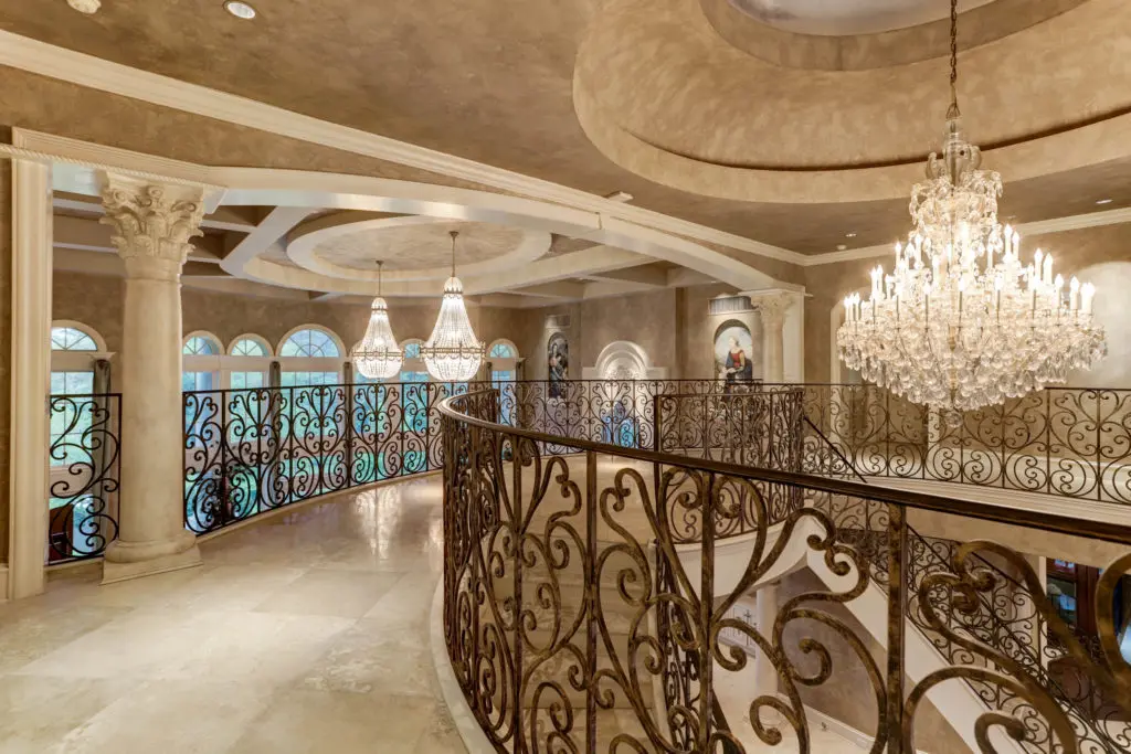 The landing at the top of the dual staircase offers stunning views into the living room. (Photo by TK Images)