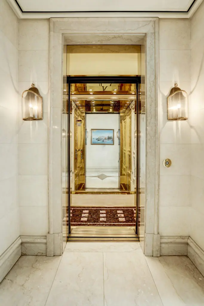 A recessed foyer for the functioning elevator at 1000 Kirby boasts double polished-brass elevator doors and is flanked by stunning French-style lanterns. (Photo by TK Images)