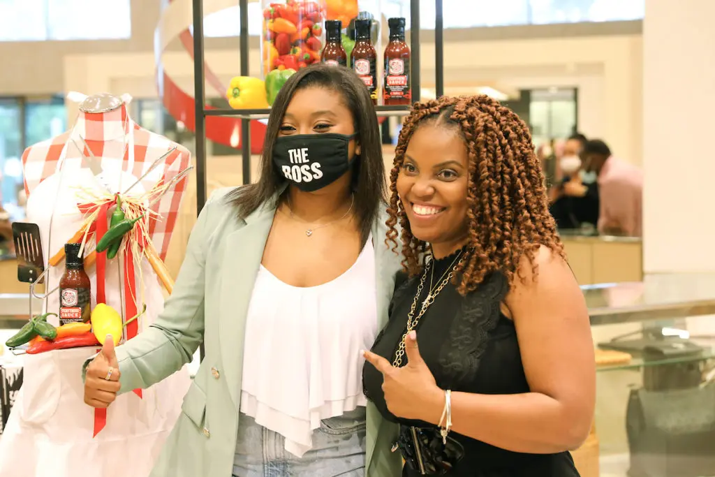 Sienna Sauce founder Tyla-Simone Crayton shares a photo opp with a fan in the designer handbag salon of Neiman Marcus in the Galleria. (Photo by Priscilla Dickson)