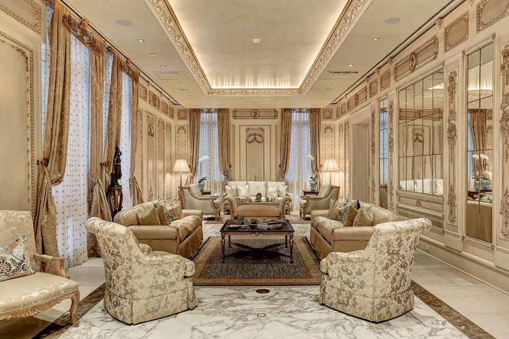 The formal reception parlor features soaring 12’ ceilings, imported Calacatta Gold marble floors with inlays, casement windows with custom silk draperies, and paneled walls with gilt-edged framing. (Photo by TK Images)