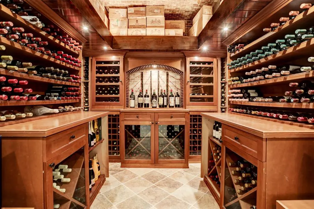 Behind the opulent formal dining room, lies a walk-in, climate-controlled 1000 bottle wine vault.  (Photo by TK Images)